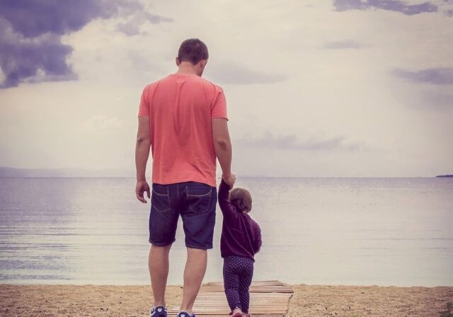 father with child on a beach