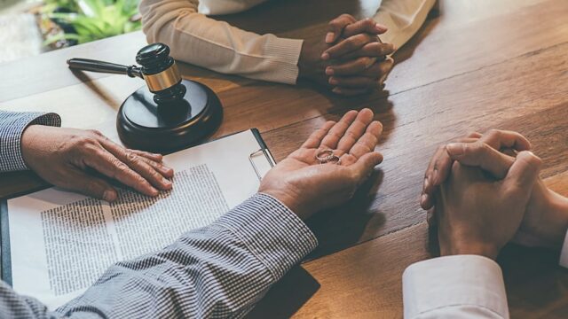 people sitting around document at a table