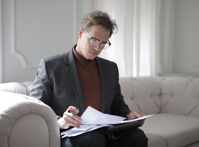 man looking at papers