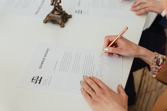 couple signing divorce documents