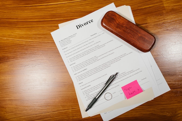 divorce papers, pen, and ring